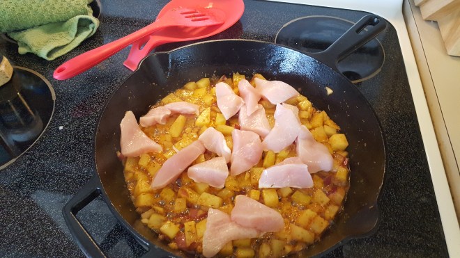 raw chicken added to potatoes