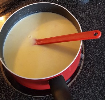 Cooking bechamel and tomato sauce for moussaka.jpg