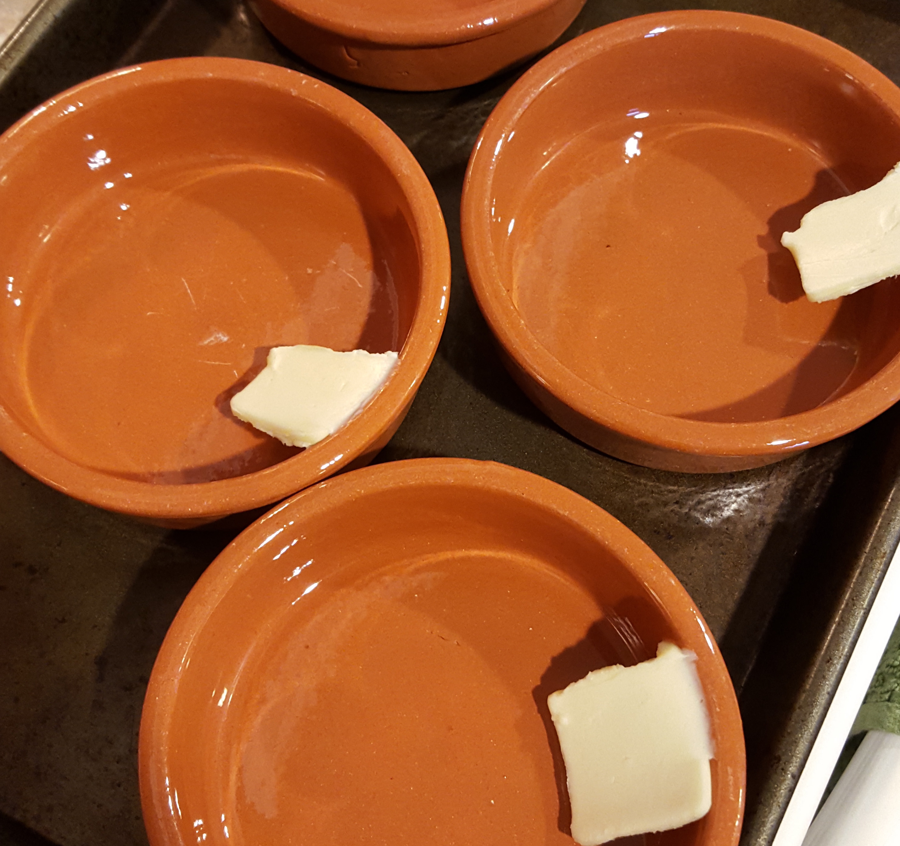 Butter to grease ramekins